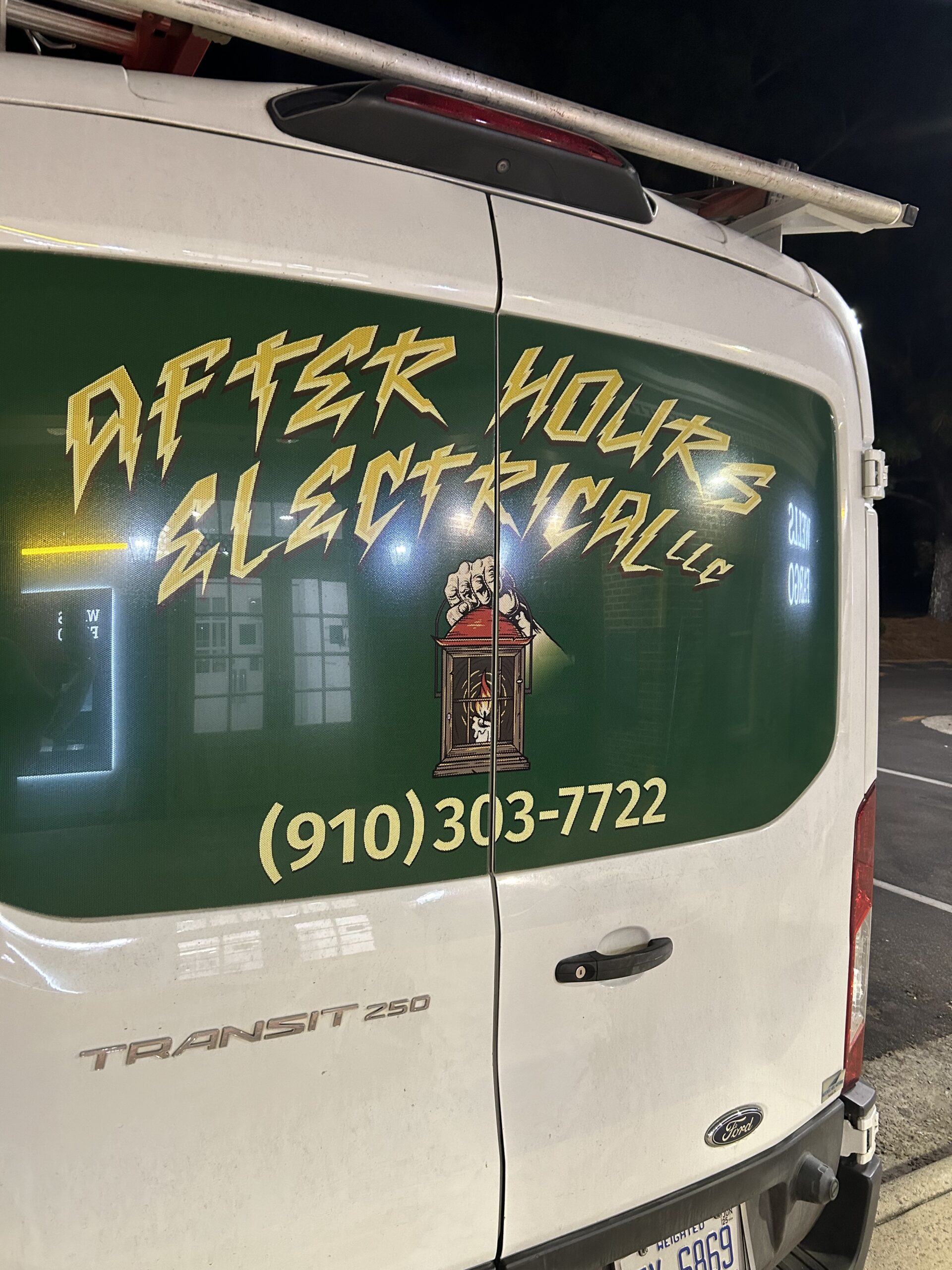 A white van with After Hours Electrical LLC and a phone number printed on the back doors, along with an image of a clock and a partial license plate visible.